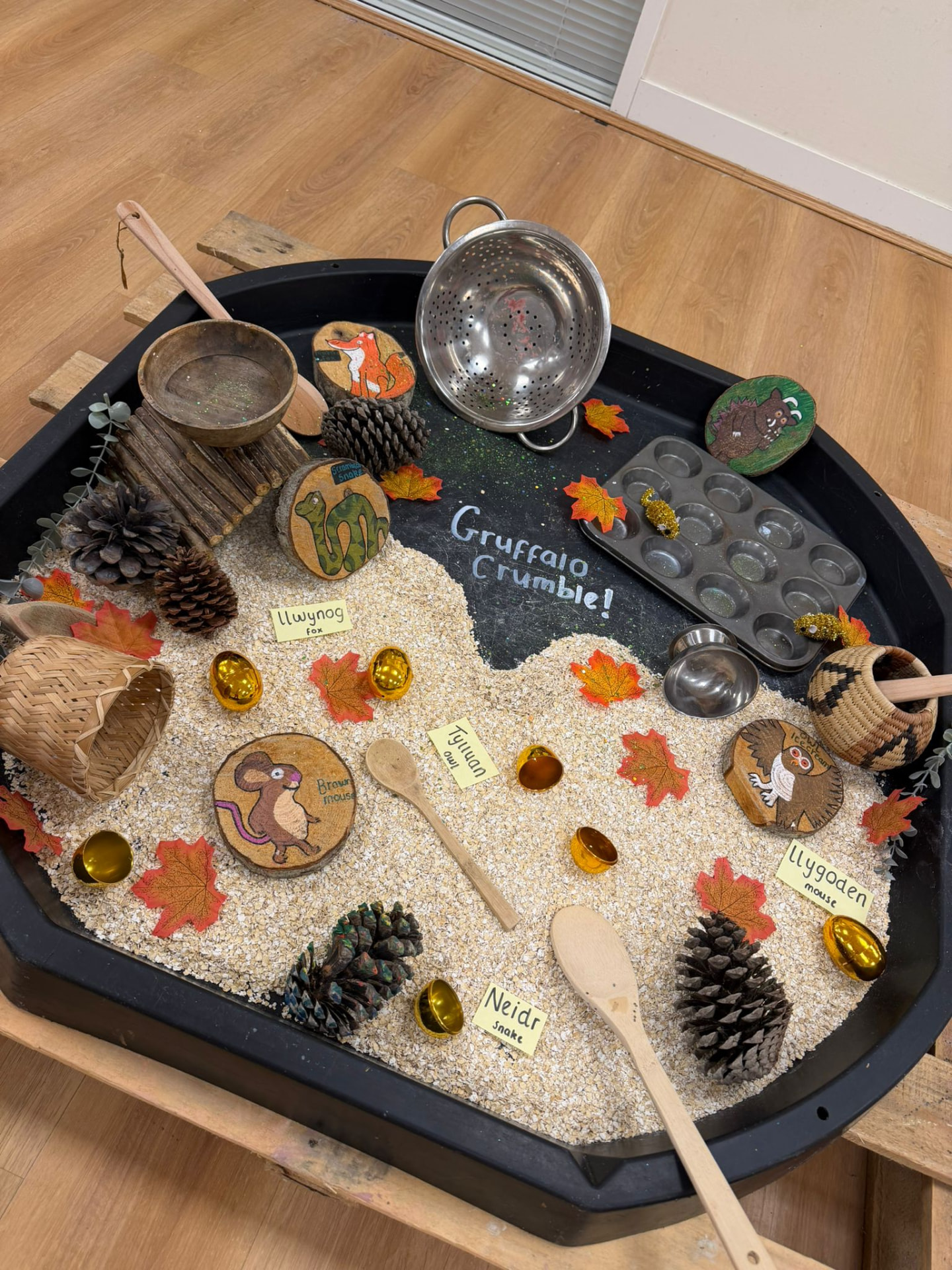 A Gruffalo-themed sensory tray with natural materials and story props at Wibli Wobli Newport
