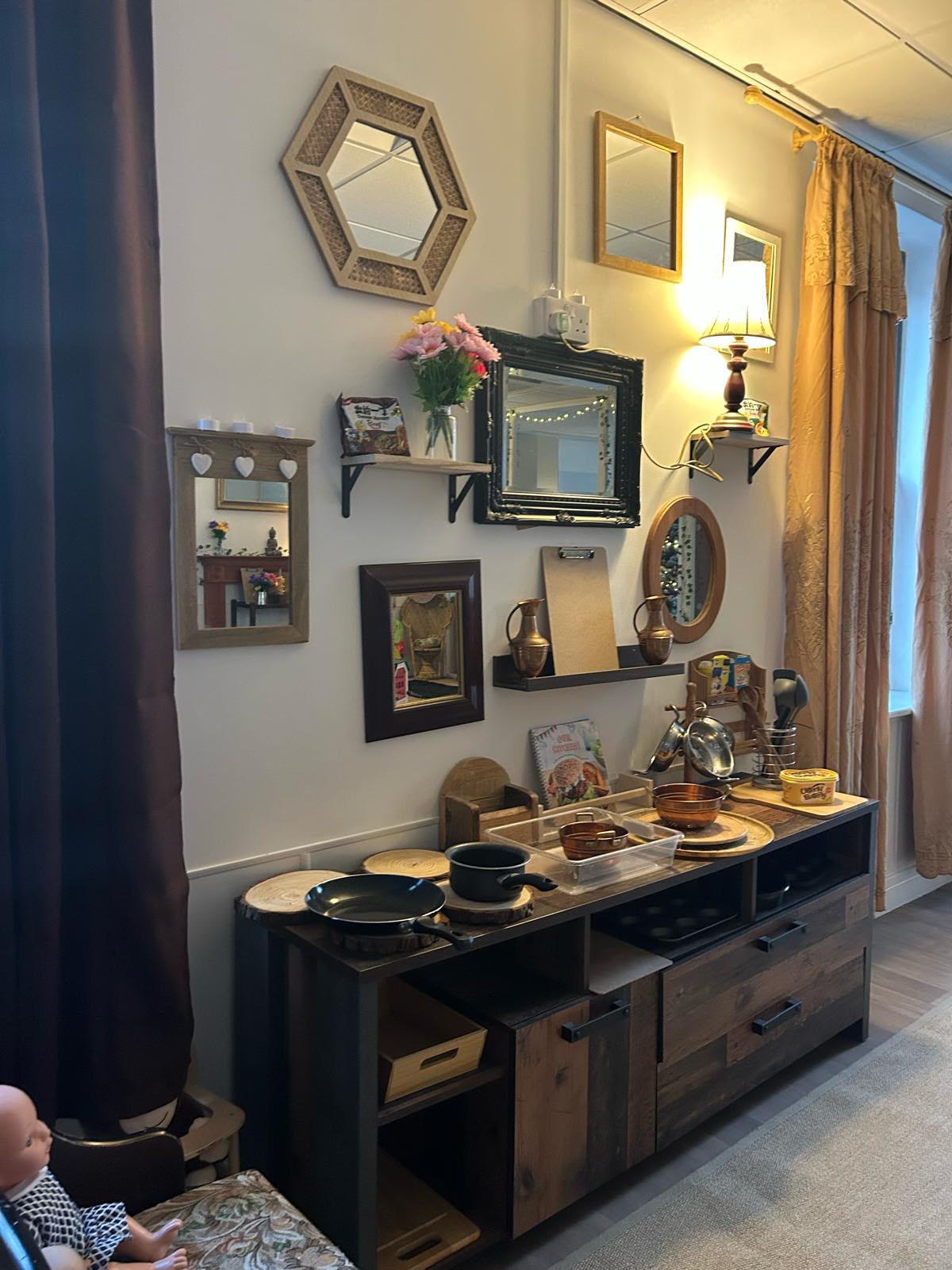 Homely role-play kitchen with real pans, mirrors and lamps at Wibli Wobli nursery Cardiff